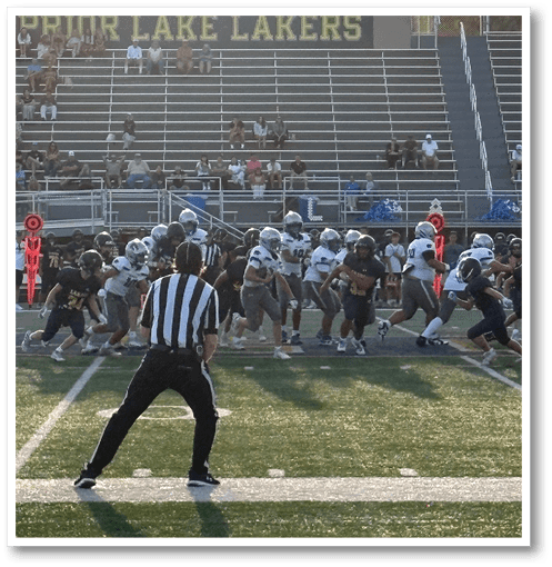 A football player wearing a black jersey with the number 6 on it. Description generated by AI