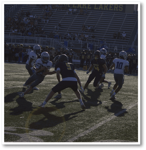 A football player wearing a black jersey with the number 6 on it. Description generated by AI