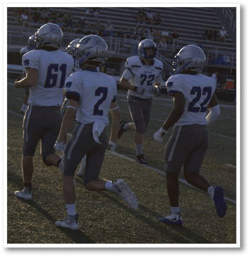 A football player wearing a black jersey with the number 6 on it. Description generated by AI