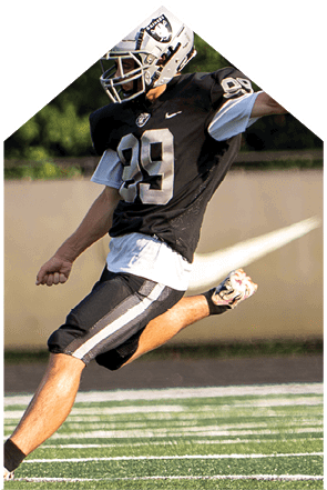 A young man wearing a white jersey with the number 10 on it. Description generated by AI