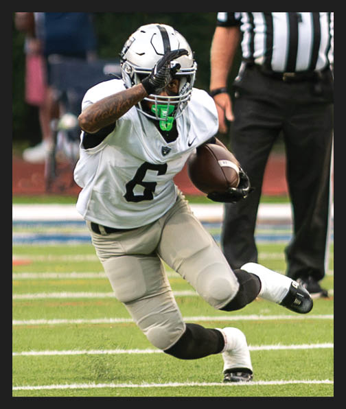 A football player in a white uniform is running with a football in his hand. AI generated content