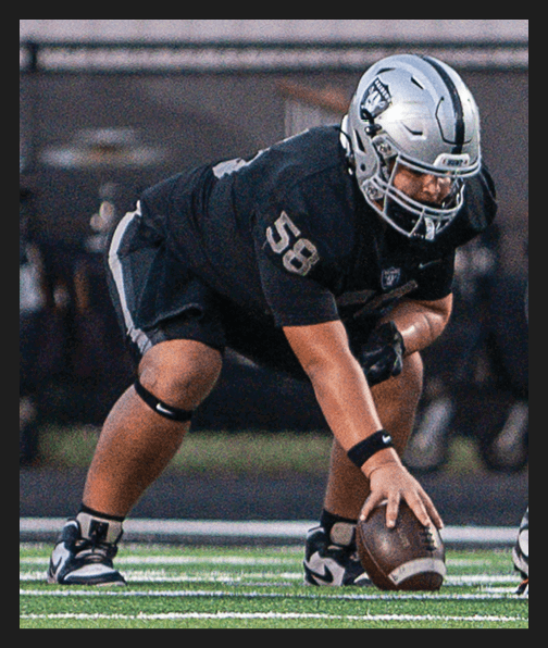 A football player in a white uniform is running with a football in his hand. AI generated content