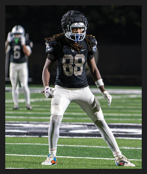 A football player in a white uniform is running with a football in his hand. AI generated content