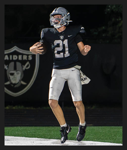 A football player in a white uniform is running with a football in his hand. AI generated content