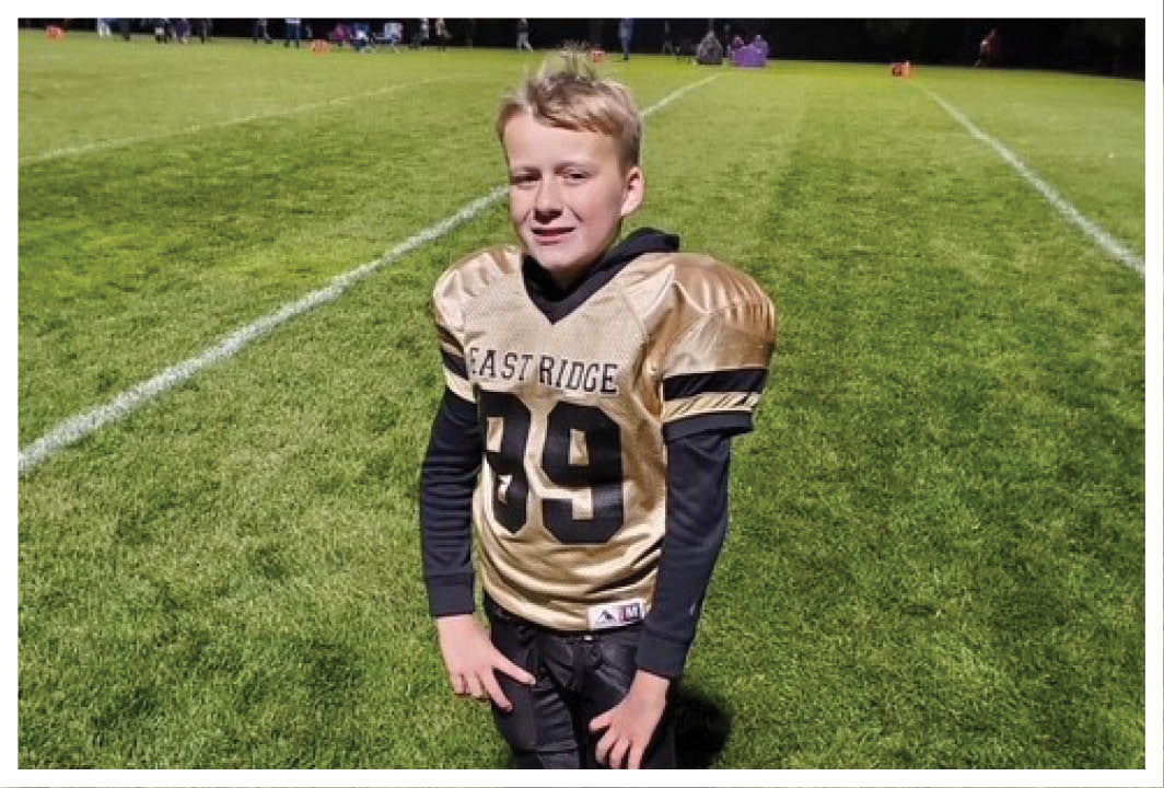 A football player wearing a blue and red jersey. Description generated by AI