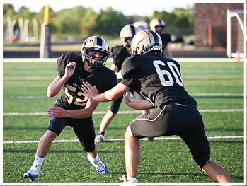 A football player running on the field. Description generated by AI