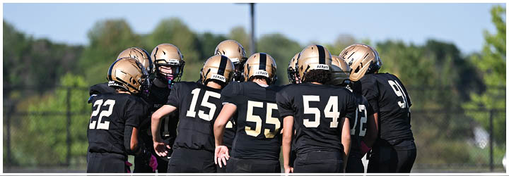 A group of football players on a field. Description generated by AI