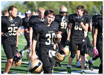 A football player running on the field. Description generated by AI