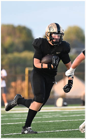 A football player running on the field. Description generated by AI