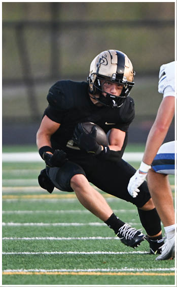 A football player running on the field. Description generated by AI