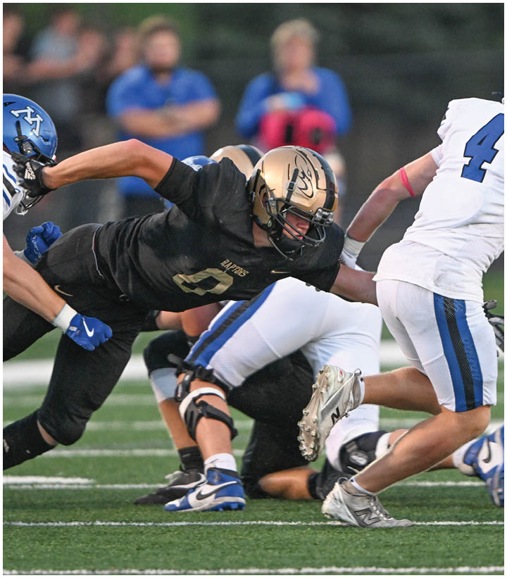 A group of football players wearing black and white uniforms. Description generated by AI