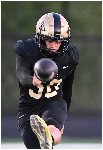 A football player running on the field. Description generated by AI