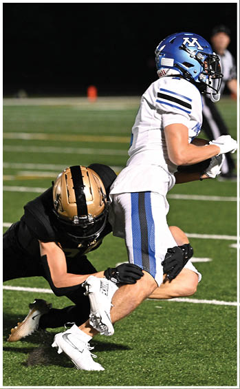 A football player running on the field. Description generated by AI