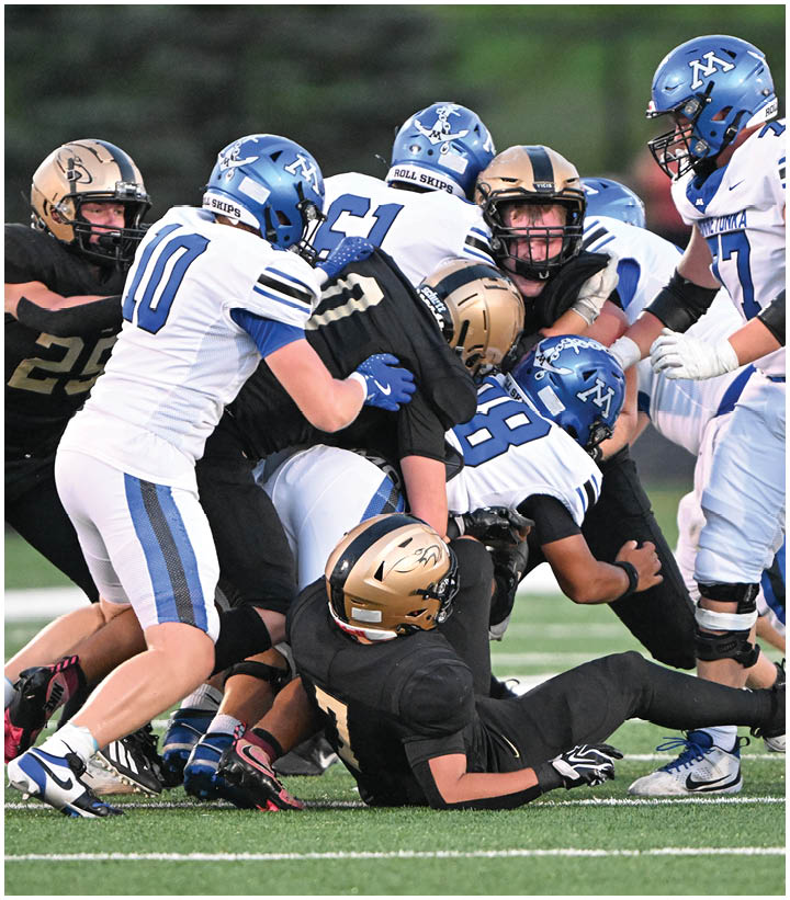 A group of football players wearing black and white uniforms. Description generated by AI