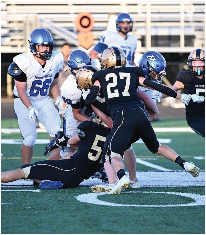A group of football players wearing black and white uniforms. Description generated by AI