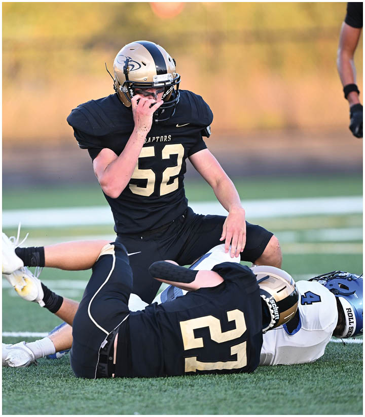 A group of football players wearing black and white uniforms. Description generated by AI