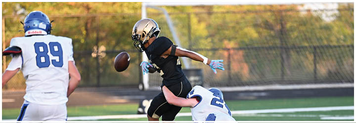 A group of football players on a field. Description generated by AI