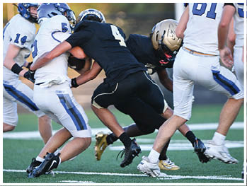 A football player running on the field. Description generated by AI