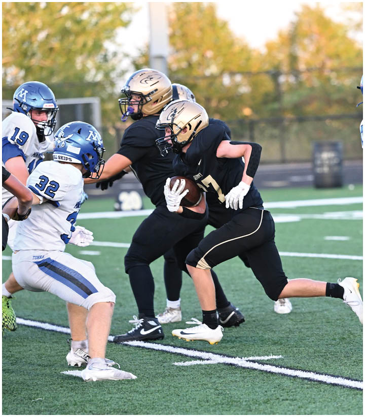 A group of football players wearing black and white uniforms. Description generated by AI
