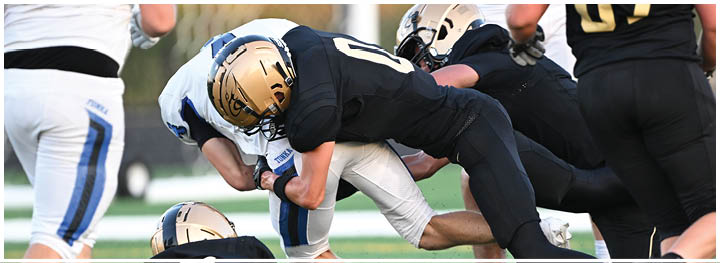 A football player is sliding on the ground. Description generated by AI