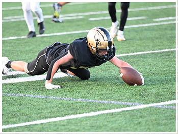 A football player running on the field. Description generated by AI