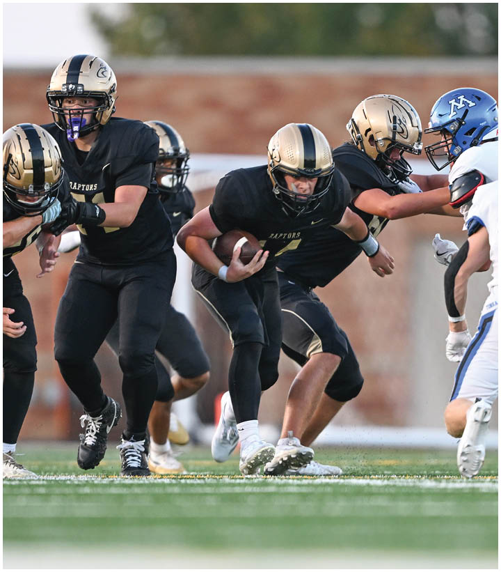 A group of football players wearing black and white uniforms. Description generated by AI