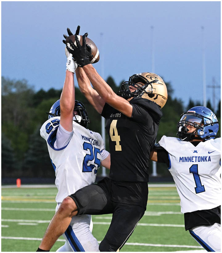 A group of football players wearing black and white uniforms. Description generated by AI