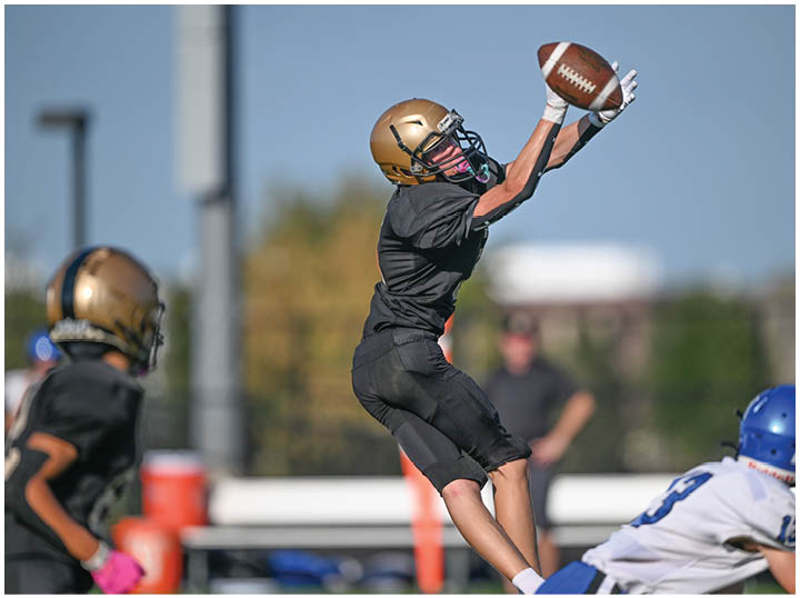 A football player is sliding on the ground. Description generated by AI