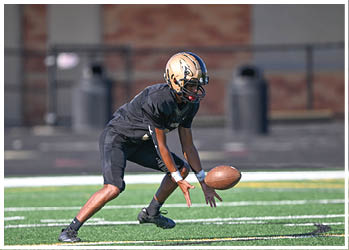 A football player running on the field. Description generated by AI