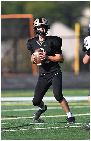 A football player running on the field. Description generated by AI