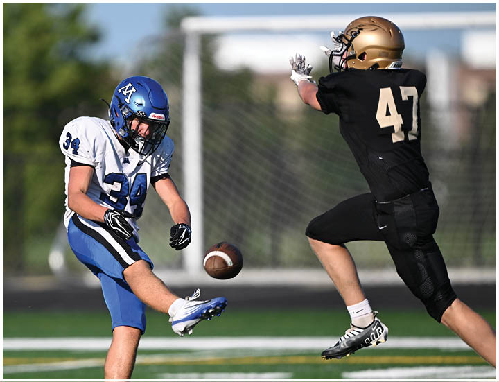 A group of football players wearing black and white uniforms. Description generated by AI