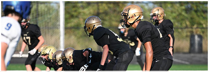 A group of football players on a field. Description generated by AI