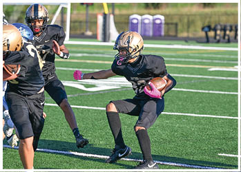 A football player running on the field. Description generated by AI