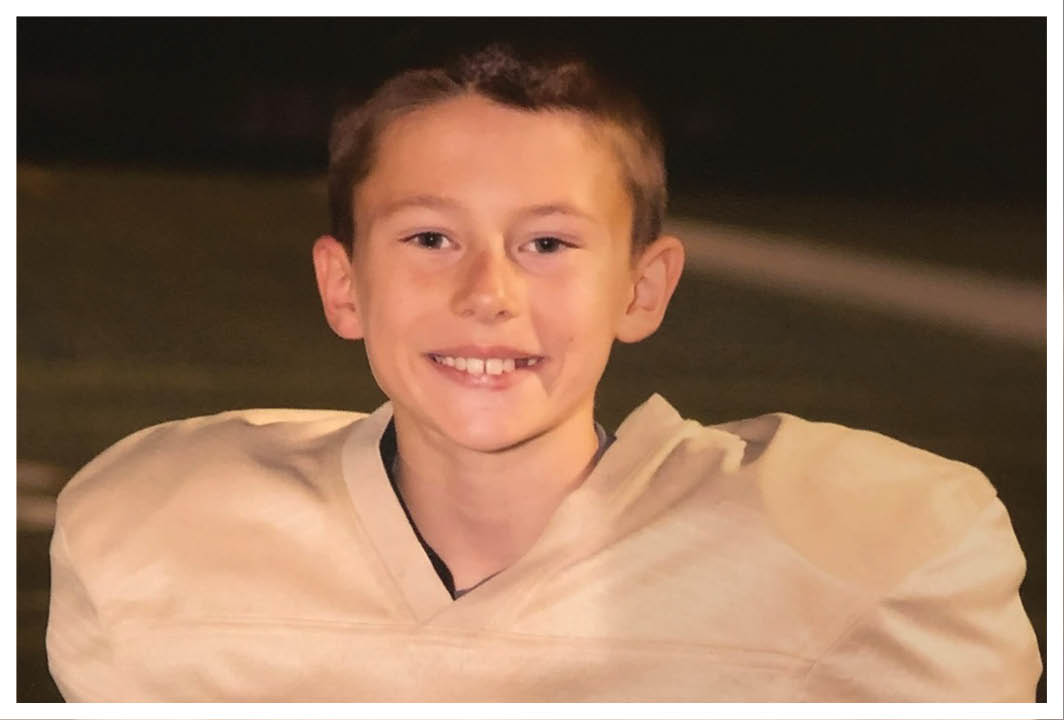 A football player wearing a blue and red jersey. Description generated by AI