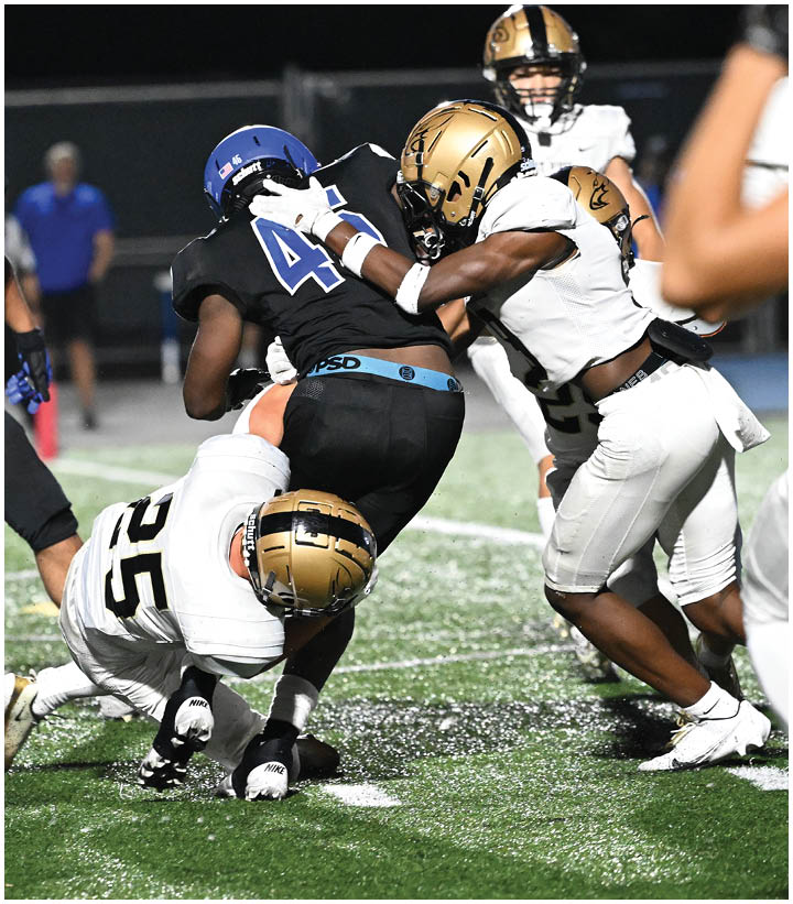 A group of football players wearing black and white uniforms. Description generated by AI