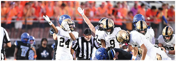A group of football players on a field. Description generated by AI