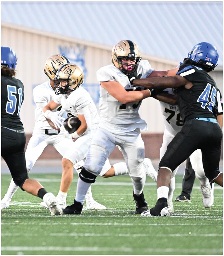 A group of football players wearing black and white uniforms. Description generated by AI