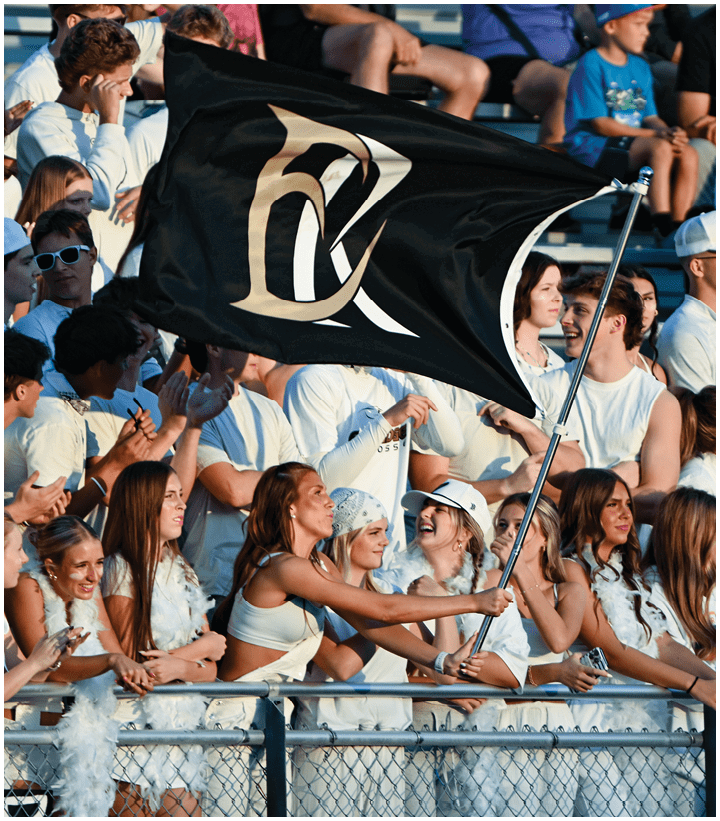 A group of football players wearing black and white uniforms. Description generated by AI