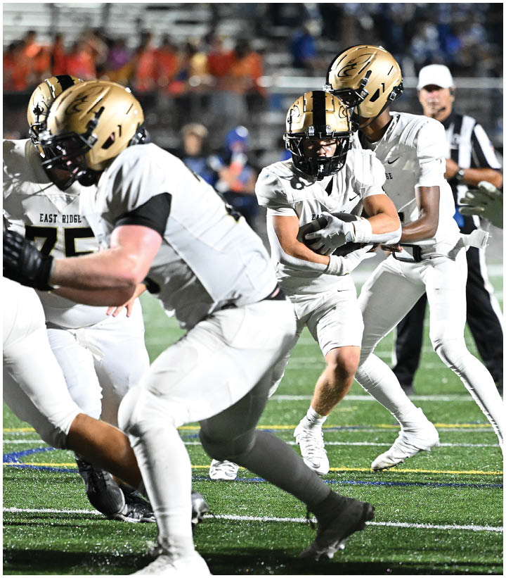 A group of football players wearing black and white uniforms. Description generated by AI