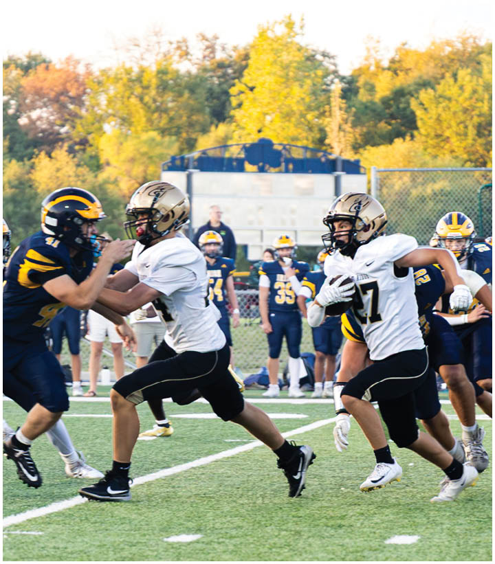 A group of football players wearing black and white uniforms. Description generated by AI