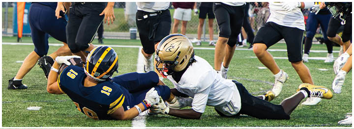 A football player is sliding on the ground. Description generated by AI