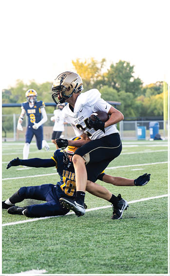 A football player running on the field. Description generated by AI