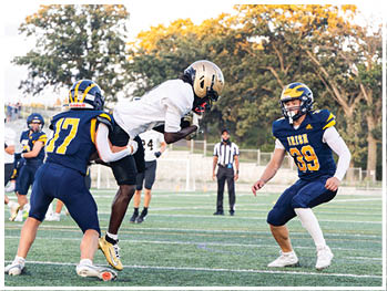 A football player running on the field. Description generated by AI