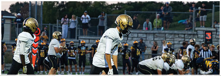 A group of football players on a field. Description generated by AI