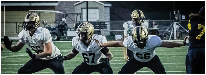 A football player is sliding on the ground. Description generated by AI