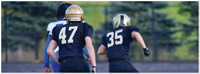 A group of football players on a field. Description generated by AI