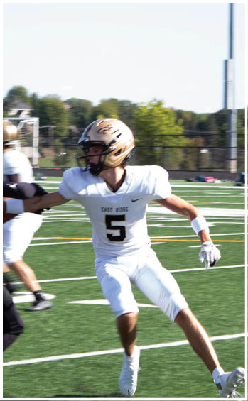 A football player running on the field. Description generated by AI