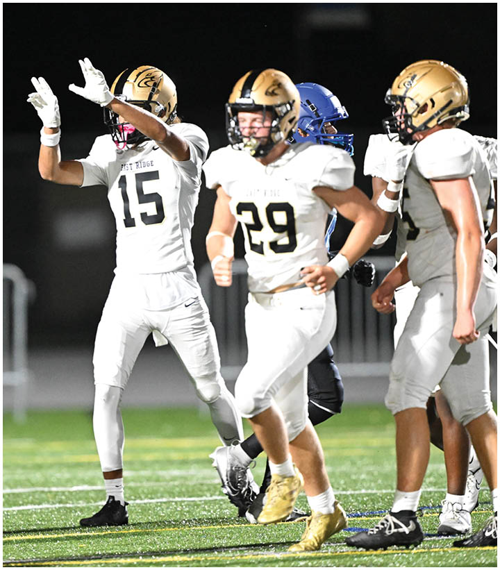 A group of football players wearing black and white uniforms. Description generated by AI