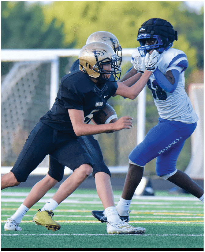 A group of football players wearing black and white uniforms. Description generated by AI