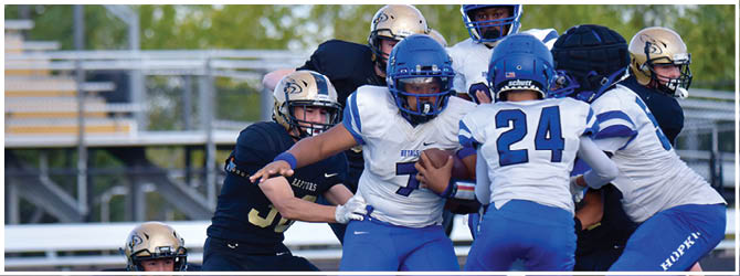 A group of football players on a field. Description generated by AI